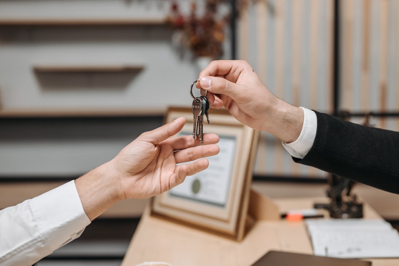 one person hands keys to another