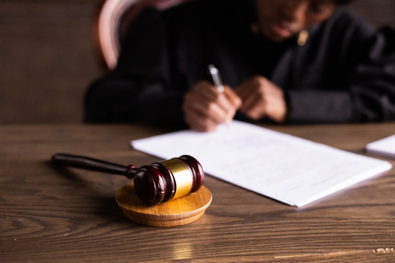 gavel and person writing